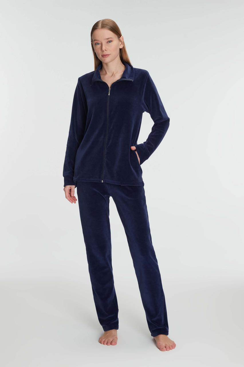 Woman wearing navy fleece pajamas on a white background