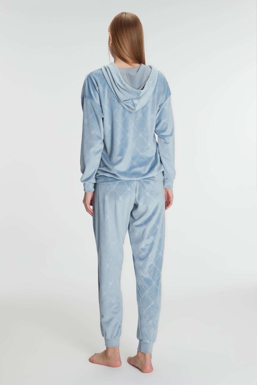 Person wearing a light blue pajama set on a white background