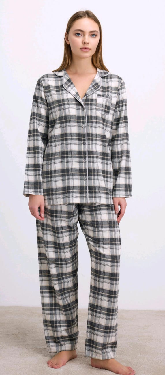 Woman wearing a plaid pajama set against a white background