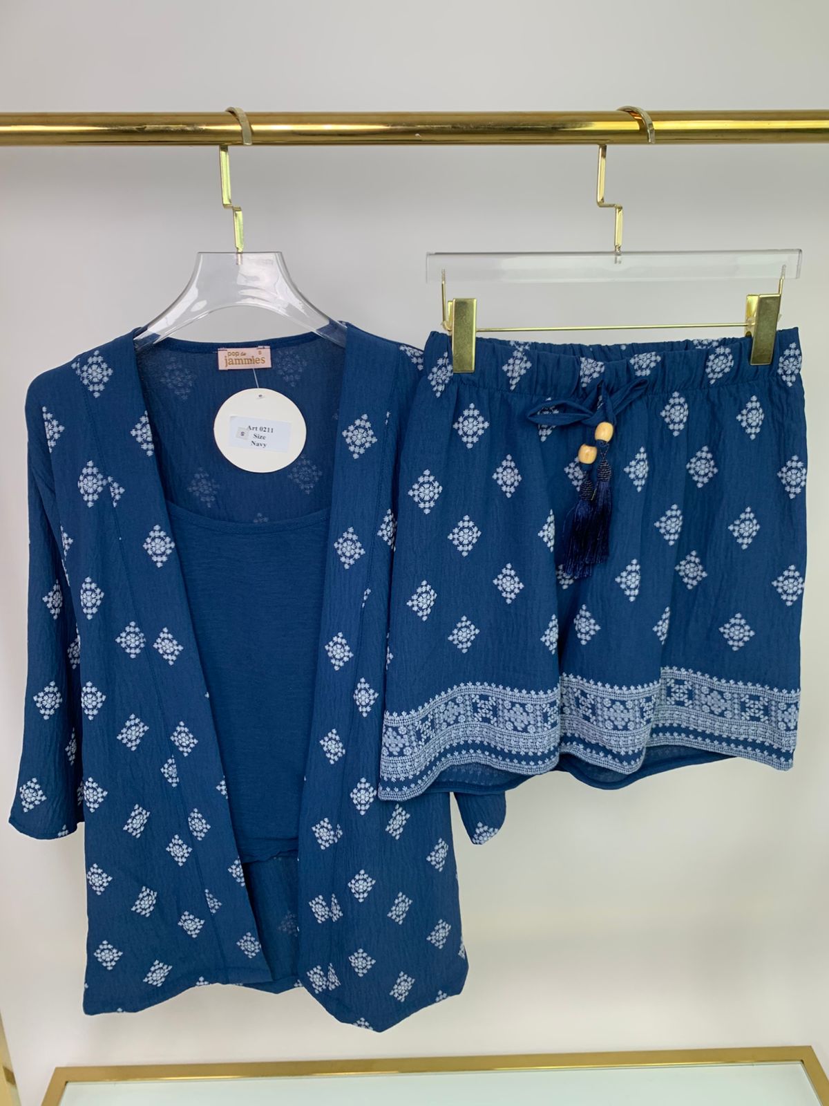 3-piece short pyjama set - pajama set - summer pajama - women pajama - Blue patterned outfit with a jacket and shorts on a hanger against a white background