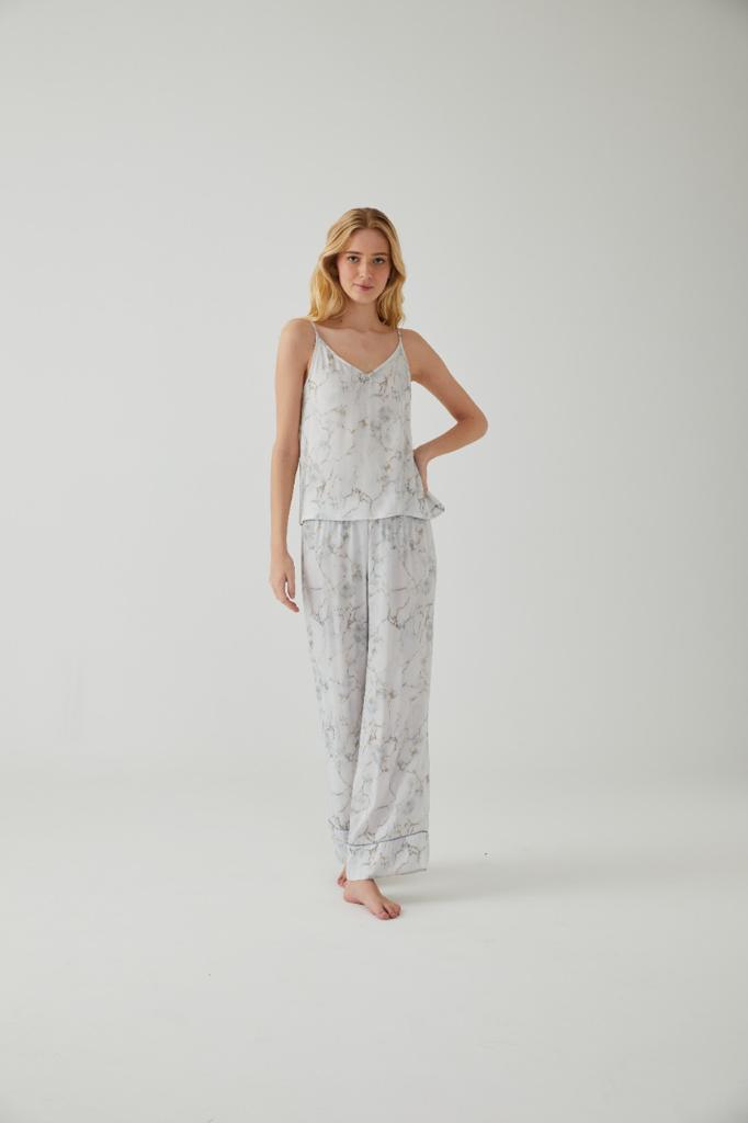 Model showcasing Marble Satin Pyjama Set by Popjammies in a bright room with a white background.