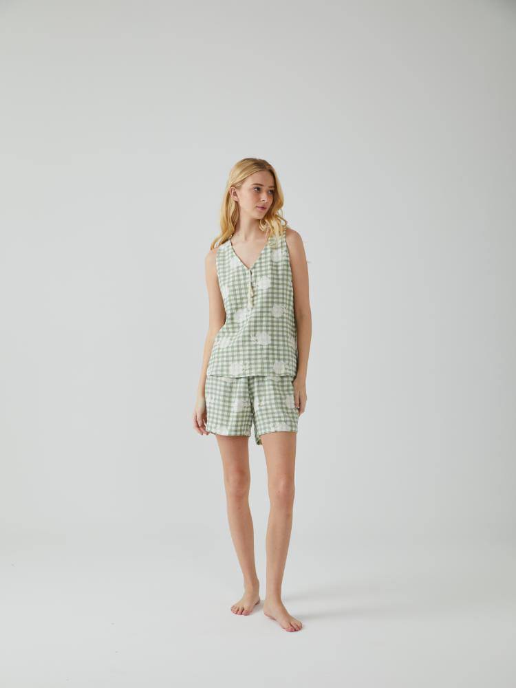 Woman wearing Popjammies Green Gingham Pyjama Set with floral accents.