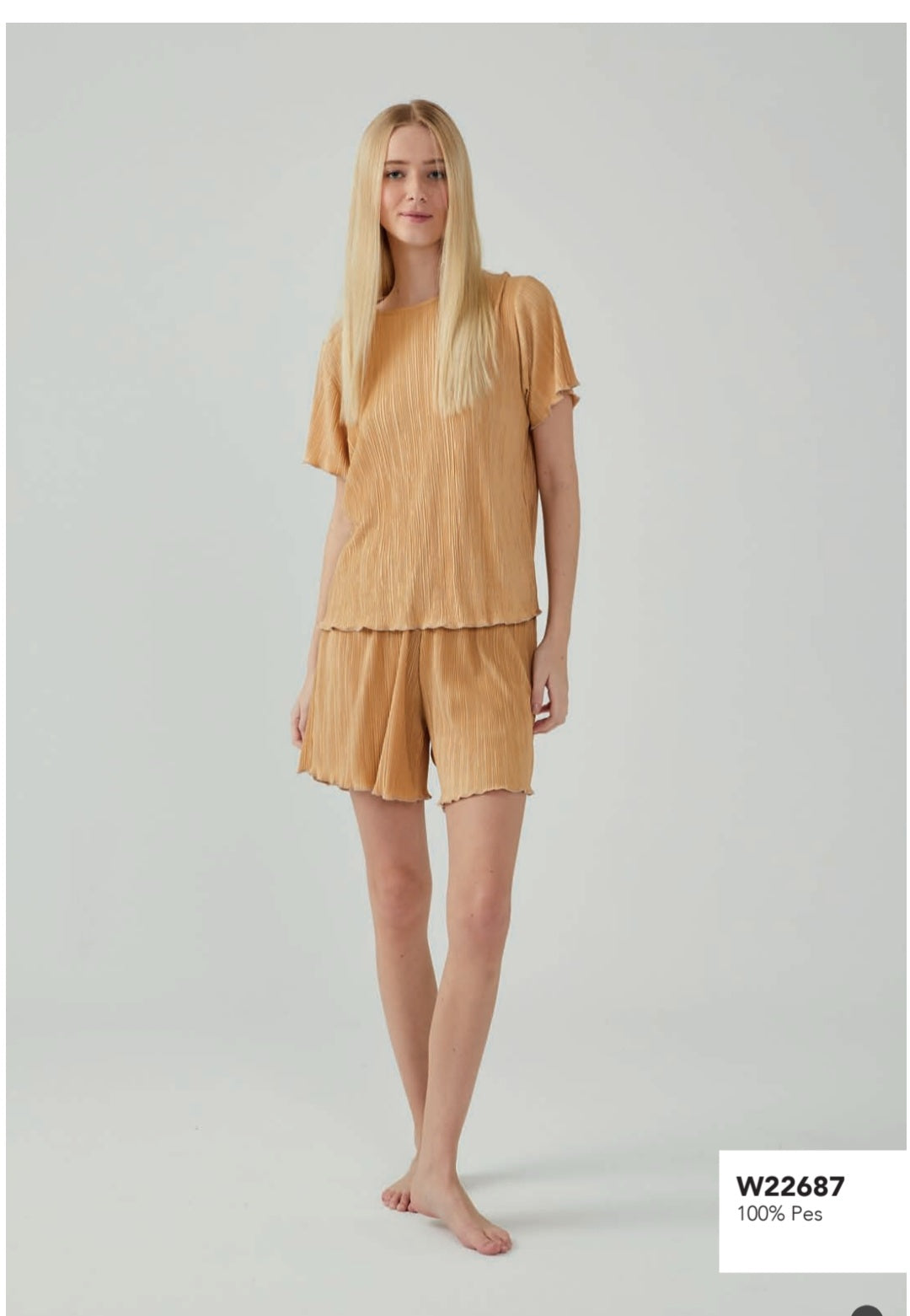 Woman wearing Popjammies Golden Pleated Pajama Set, featuring a short-sleeve top and matching shorts made from 100% polyester.