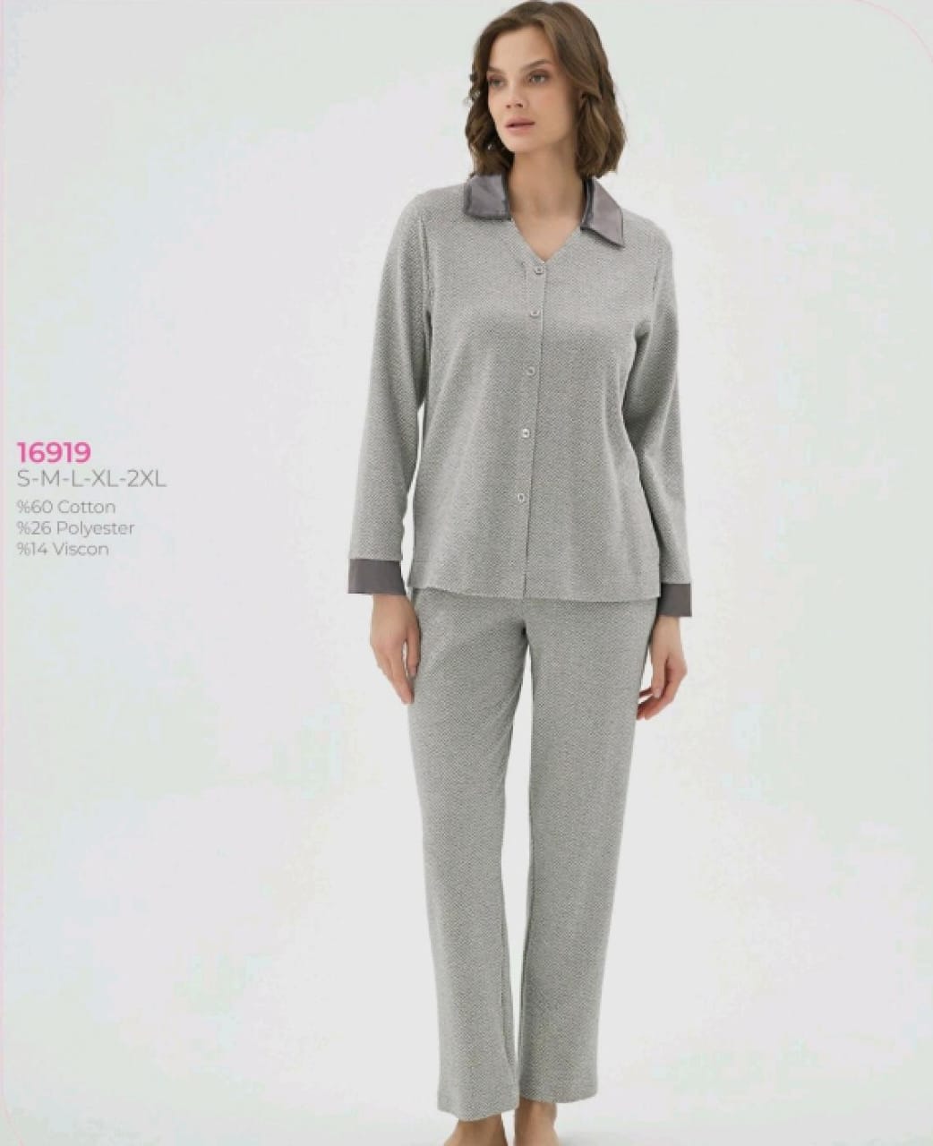 Woman wearing a gray pajama set on a white background