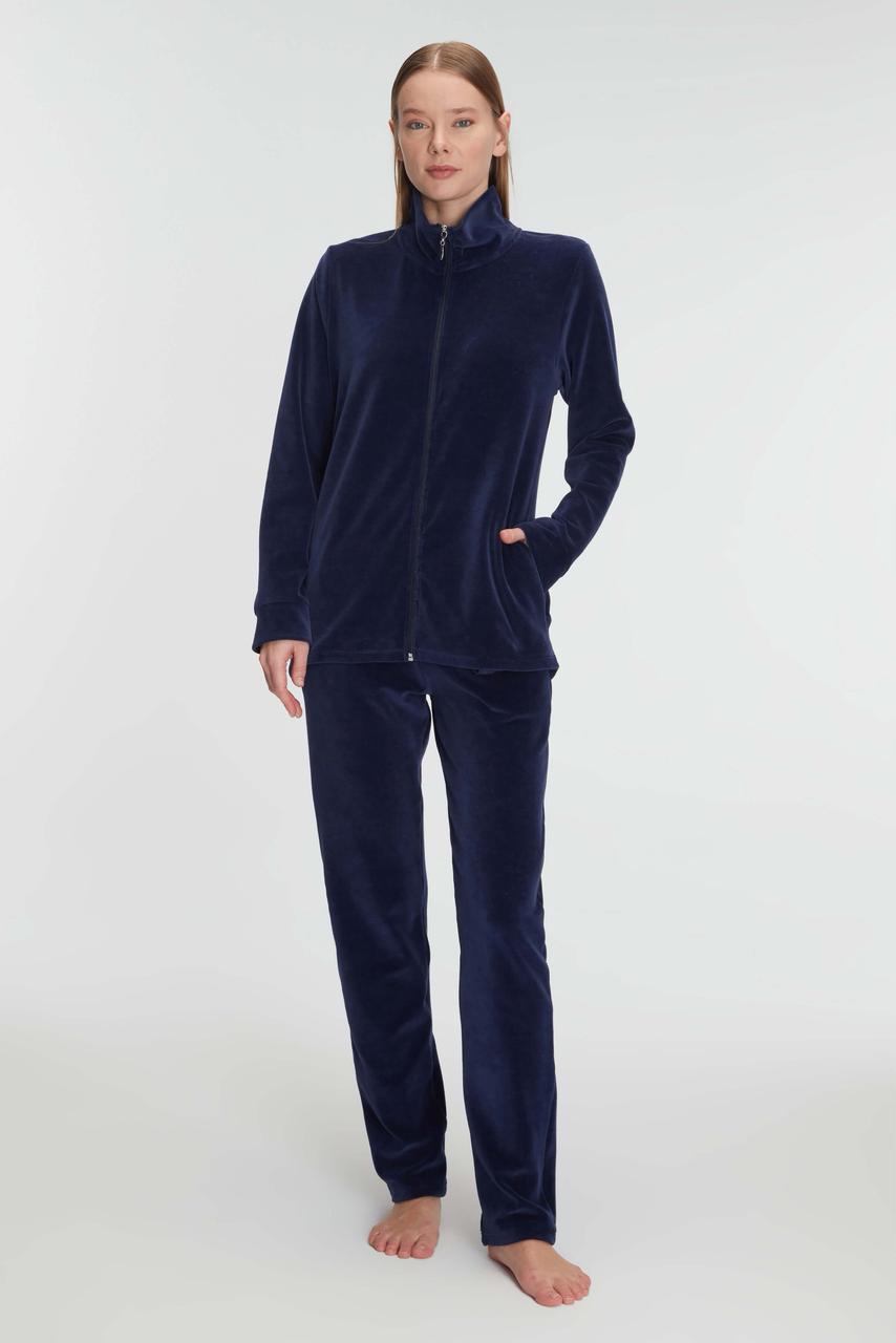 Person wearing navy blue fleece pajamas on a white background