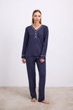 Woman wearing navy blue pajamas with a white background