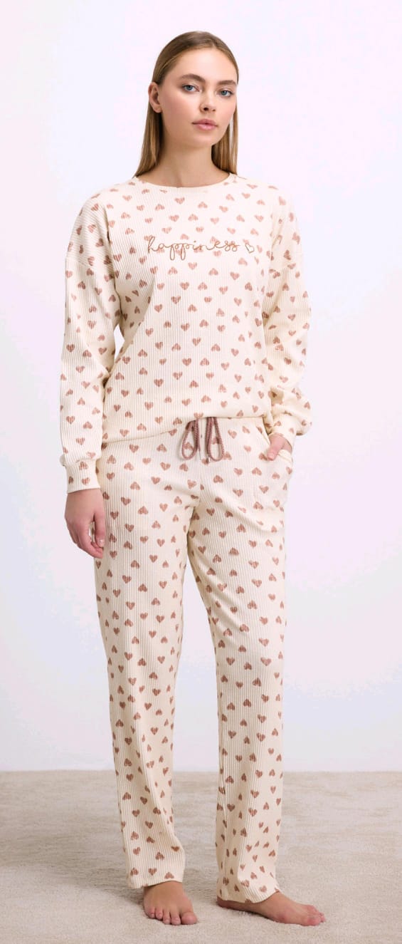 Woman wearing a patterned pajama set with text on a plain background