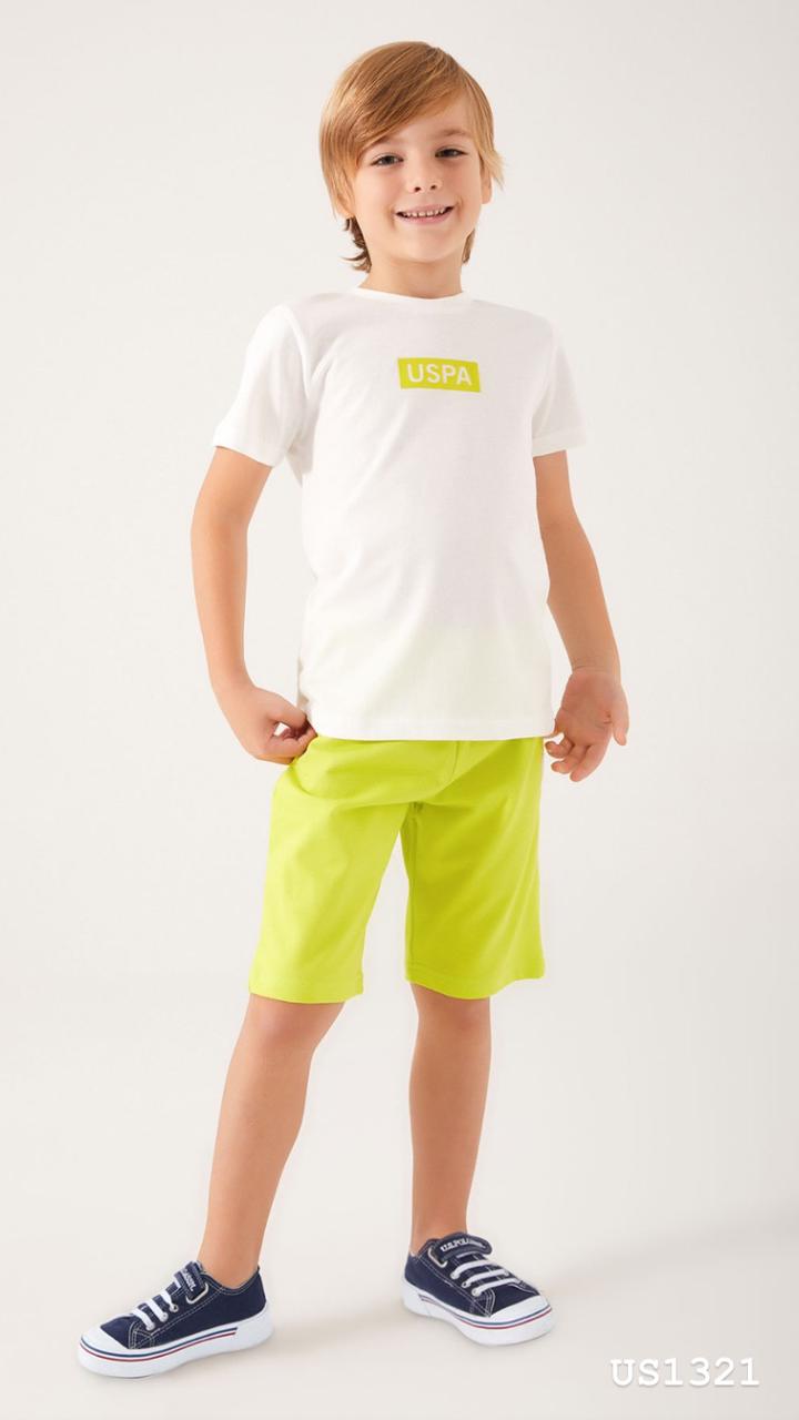 Child wearing Popjammies USPA Neon Pyjama Set with white top and neon yellow shorts standing with hands on hips