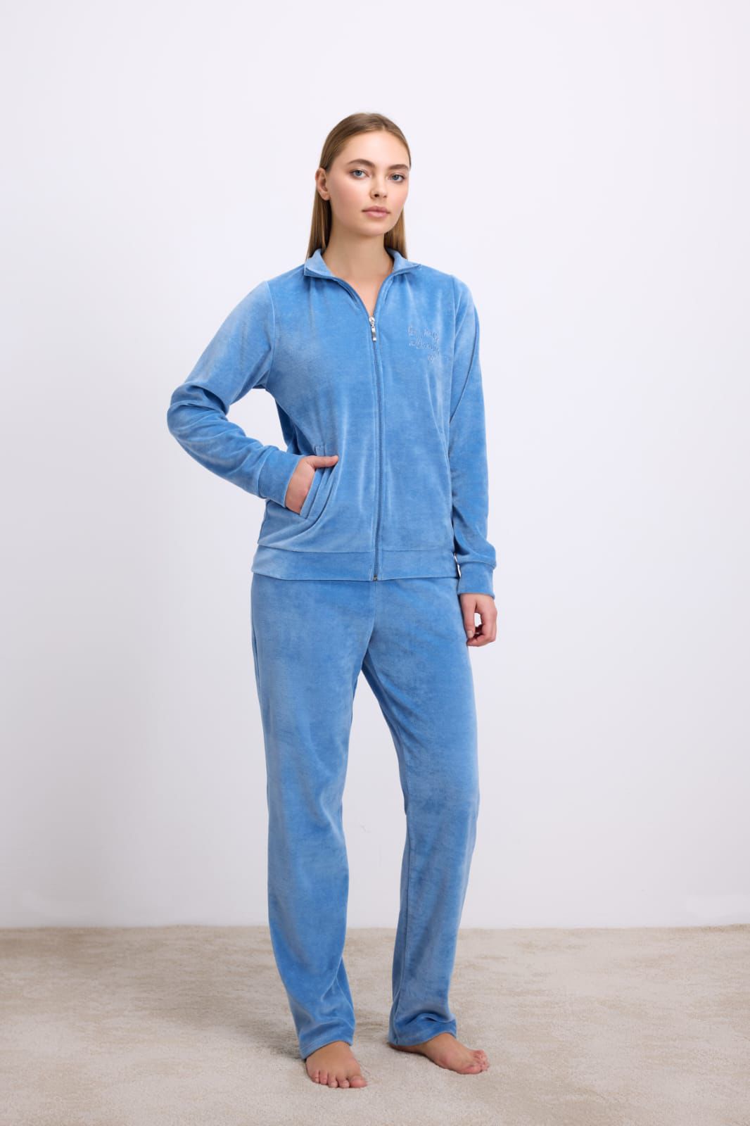 Woman wearing a blue tracksuit on a white background