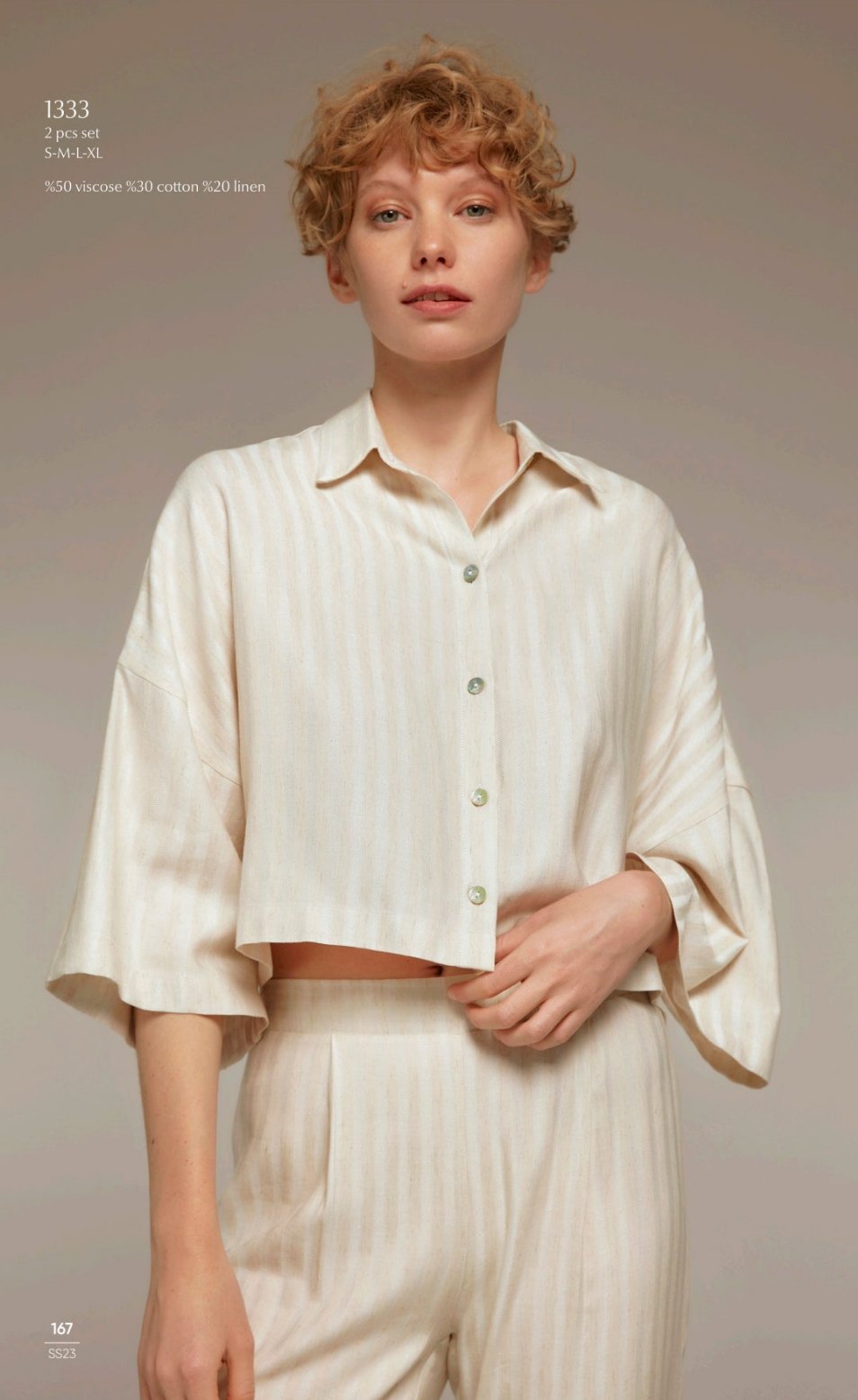 Model wearing the Popjammies 1333 Two-Piece Pyjama Set in cream, featuring a button-down cropped top with wide sleeves and matching high-waisted trousers.