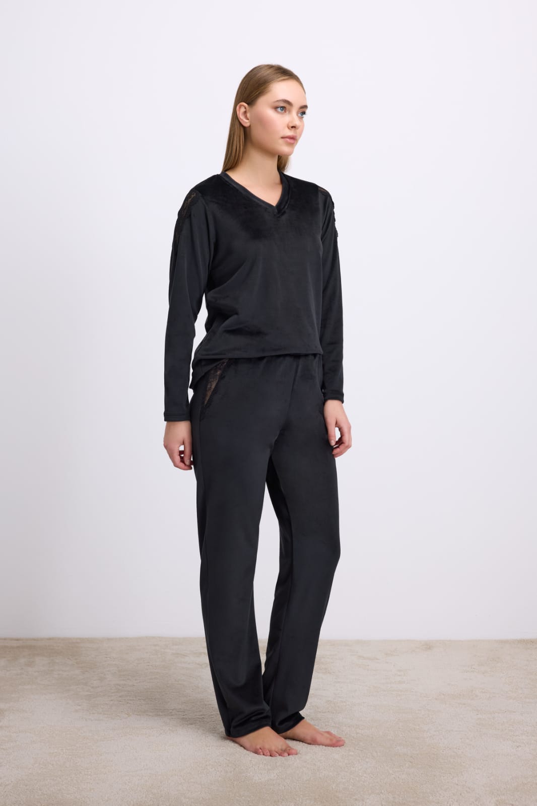Woman wearing a black outfit on a plain background