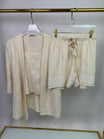 3-piece short pyjama set - pajama set - summer pajama - women pajama - Beige outfit with top and shorts hanging on a rack against a white background