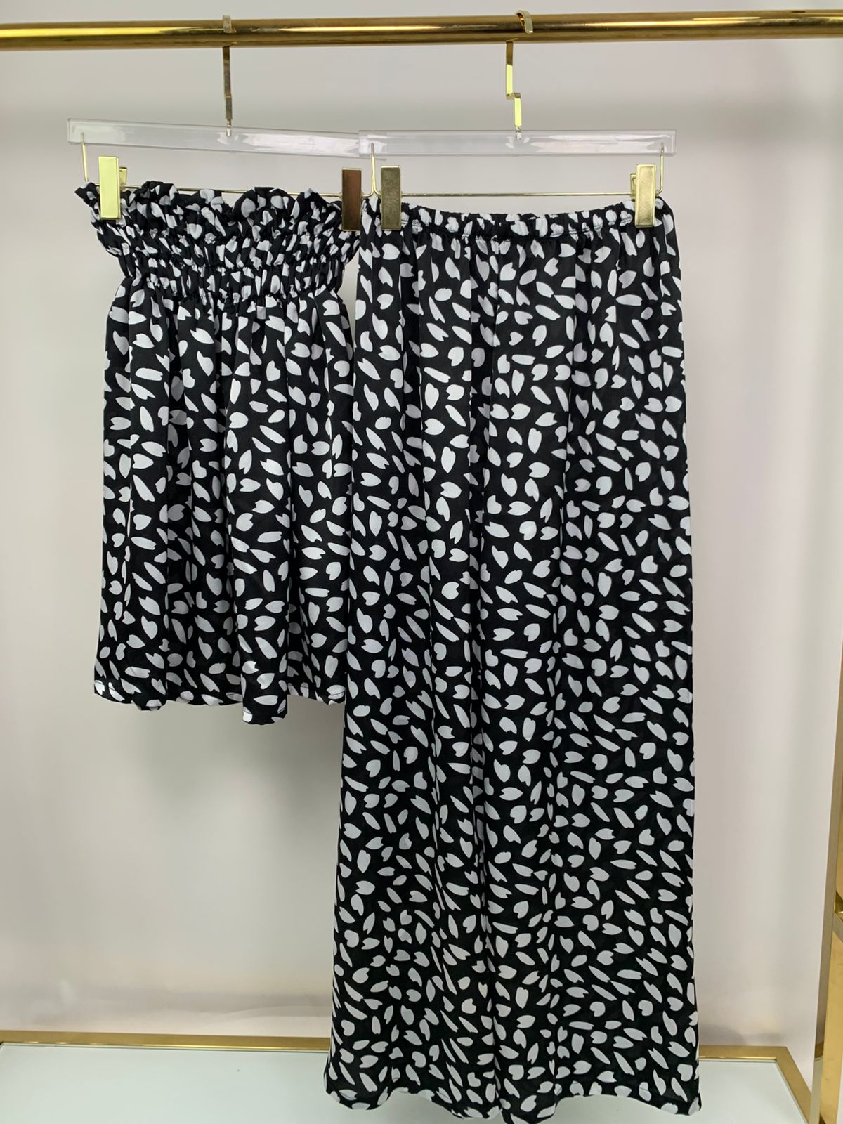 pajama set - summer pajama - women pajama - Black and white patterned skirt hanging on a rack against a plain background