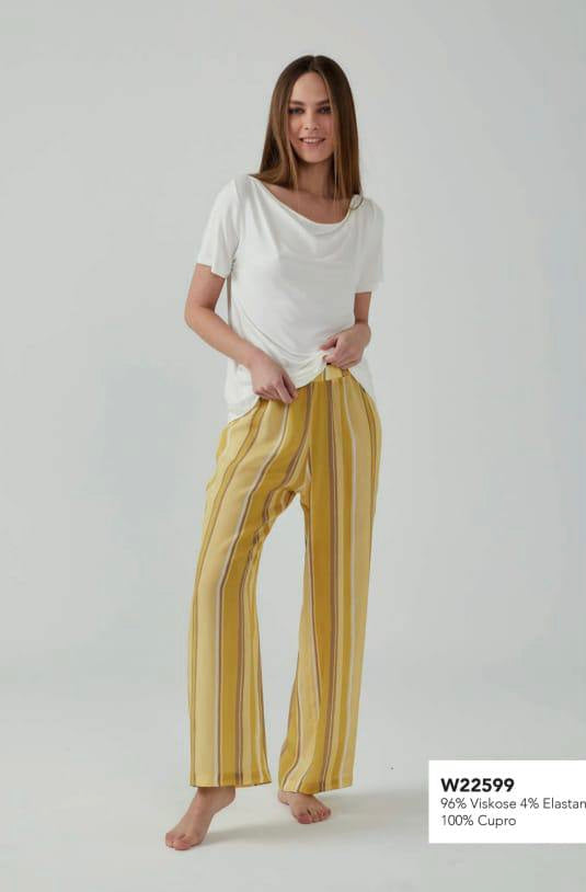 Woman wearing a white drape neckline top and yellow striped pyjama pants from Popjammies.