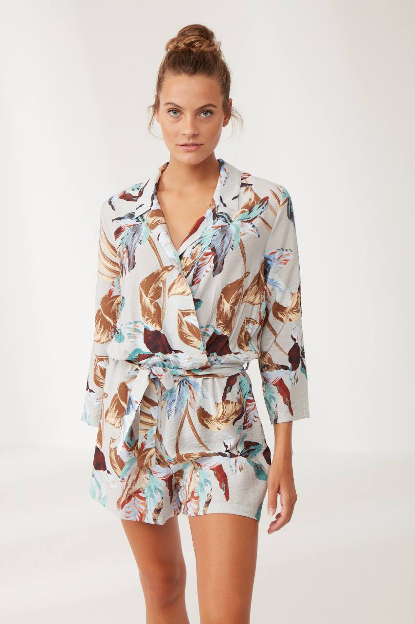Woman wearing Popjammies Tropical Print Long Sleeve Pyjama Set, featuring a vibrant tropical leaf pattern.