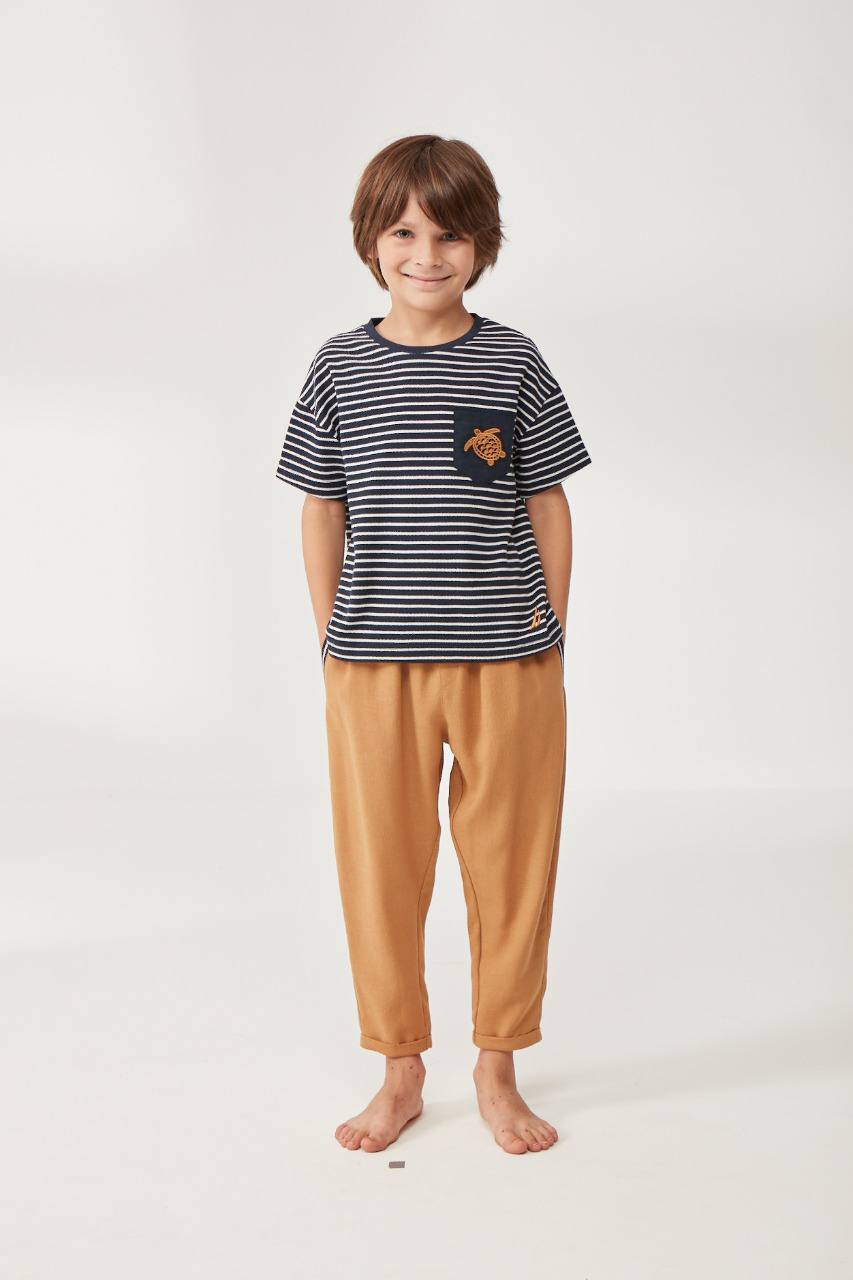 Boy wearing a navy and white striped t-shirt with a turtle pocket and caramel pants from Popjammies.